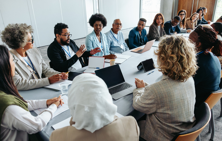 people around a conference table in discussion